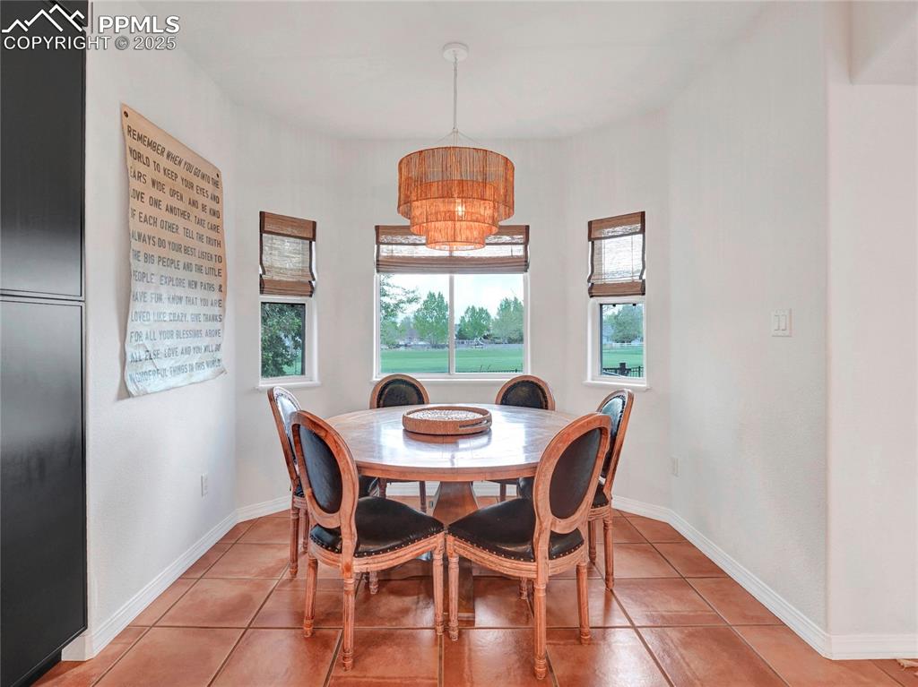 Image 12 of 44: Dining room featuring light tile patterned floors and baseboards