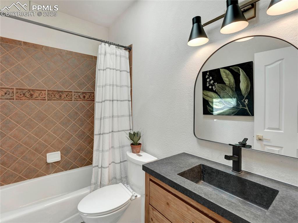 Image 24 of 44: Full bath with toilet, shower / tub combo, and vanity