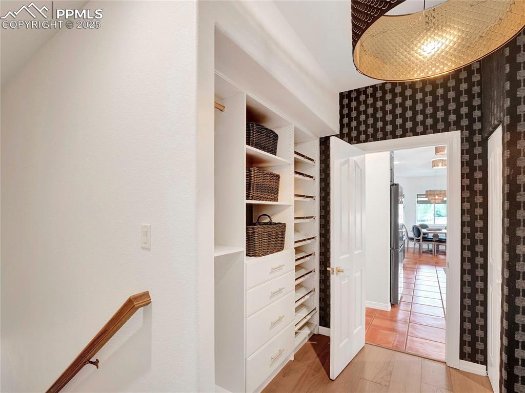 Image 27 of 44: Corridor featuring light wood-style floors and wallpapered walls