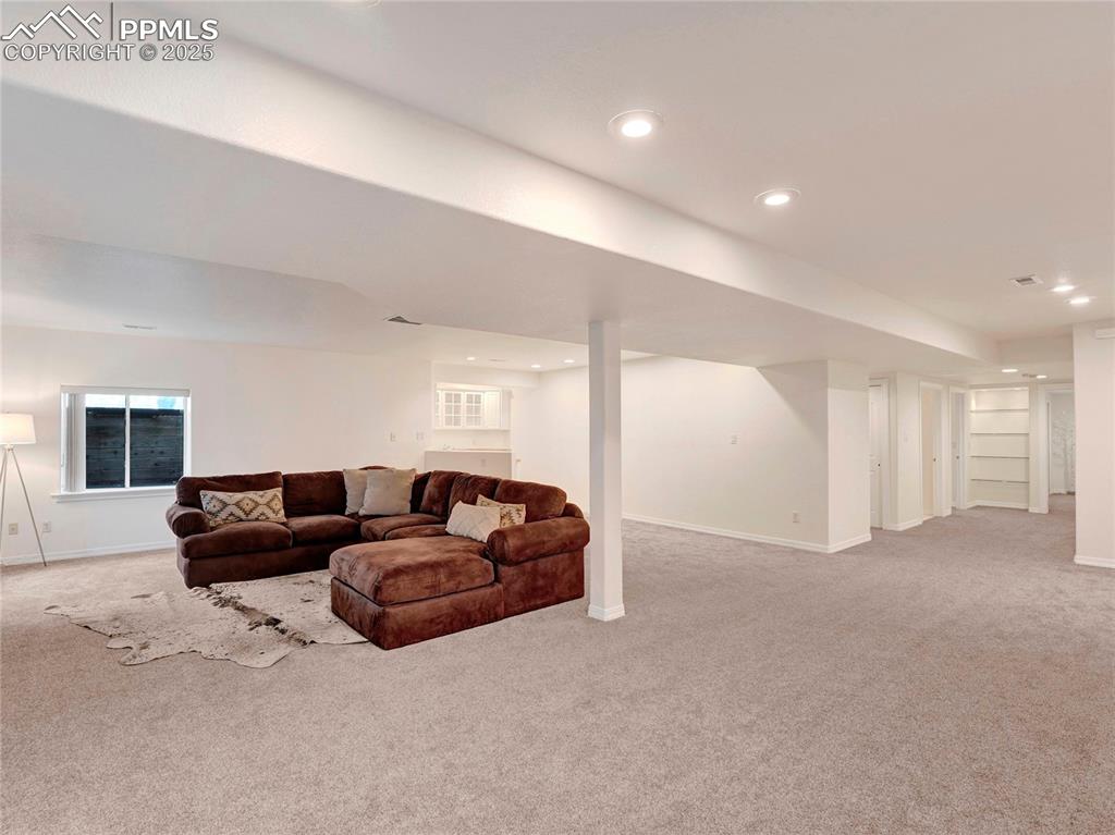 Image 28 of 44: Carpeted living area featuring baseboards and recessed lighting
