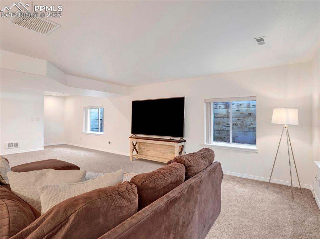 Image 29 of 44: Living room with light carpet and baseboards