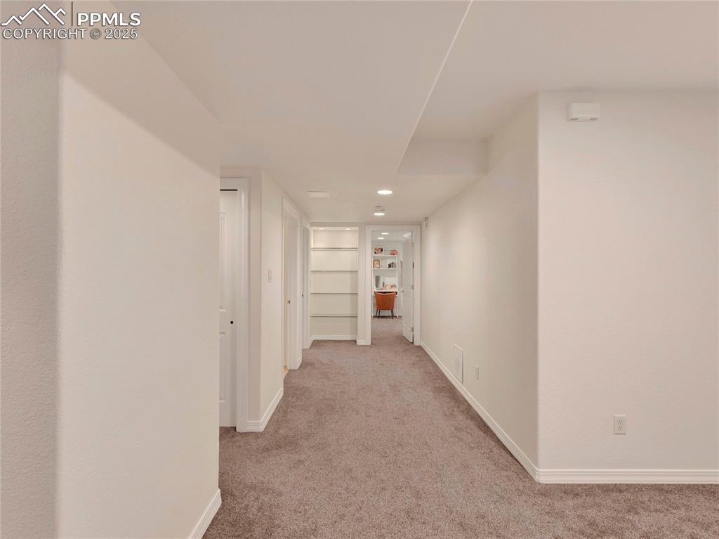 Image 33 of 44: Hall with carpet floors, baseboards, and recessed lighting