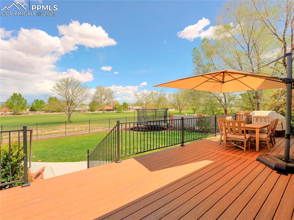 Image 39 of 44: Wooden deck featuring outdoor dining area