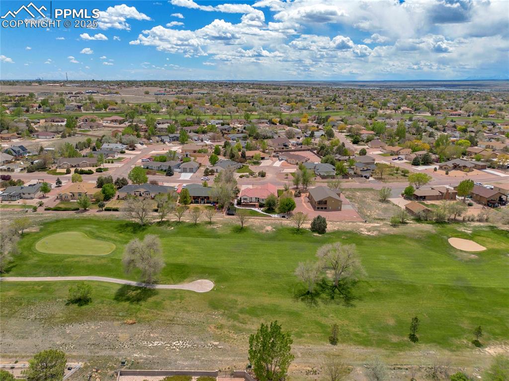 Image 43 of 44: Aerial view of residential area with a local golf course