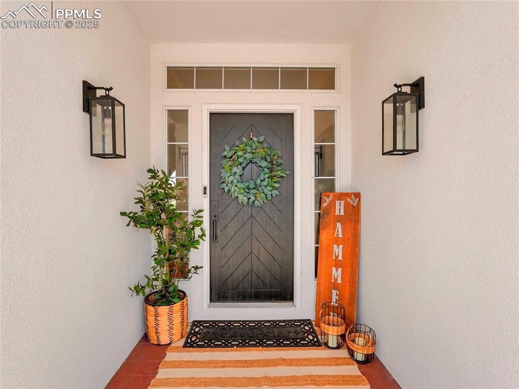 Image 6 of 44: Property entrance featuring stucco siding