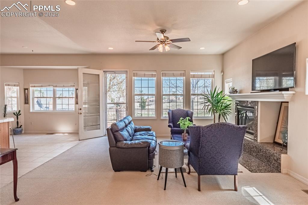 Image 10 of 49: Living area featuring recessed lighting, a high end fireplace, baseboards, 
