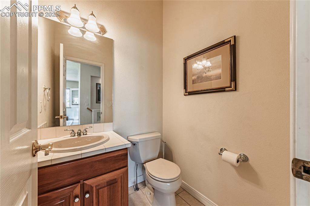 Image 19 of 49: Bathroom with tile patterned floors, toilet, and vanity