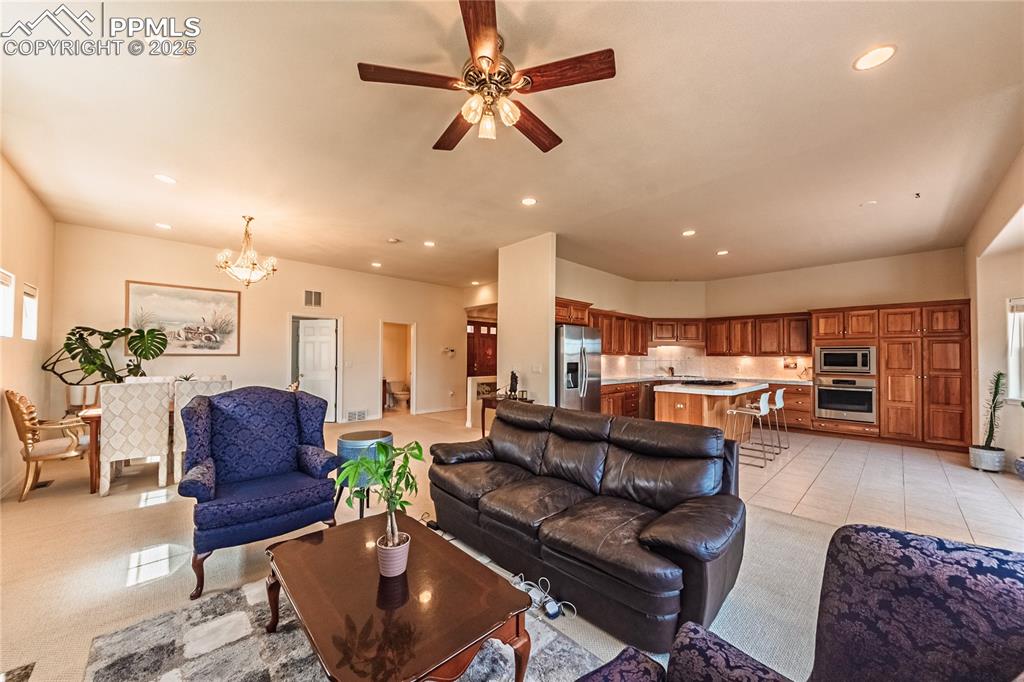 Image 23 of 49: Living room featuring visible vents, recessed lighting, and ceiling fan wit