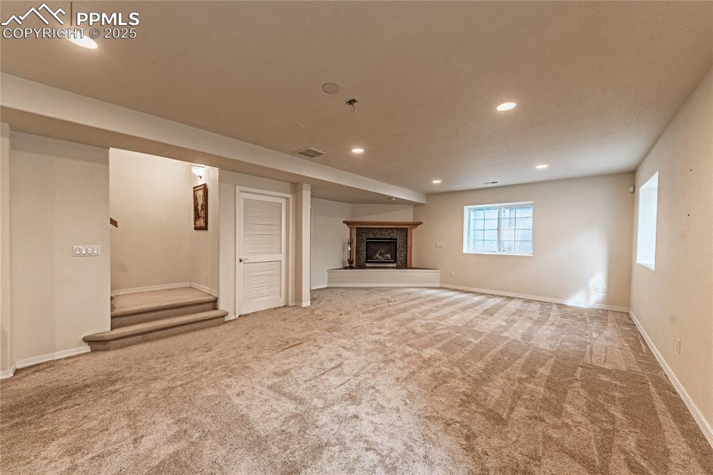 Image 36 of 49: Basement featuring baseboards, recessed lighting, carpet floors, visible ve