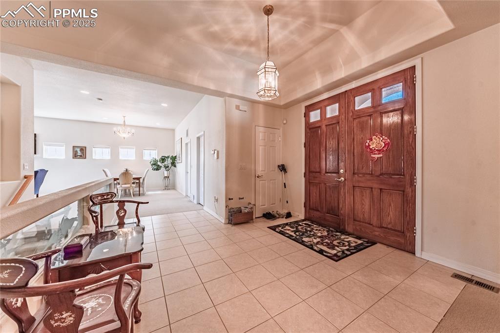 Image 4 of 49: Entryway featuring visible vents, recessed lighting, a chandelier, light ti