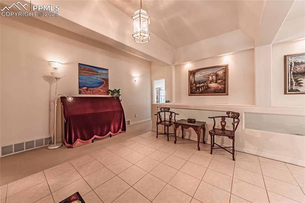 Image 5 of 49: Sitting room featuring visible vents, tile patterned flooring, and carpet f