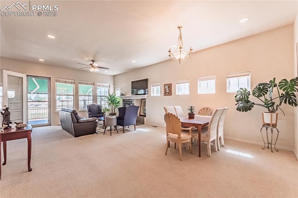 Image 7 of 49: Dining area with recessed lighting and light colored carpet