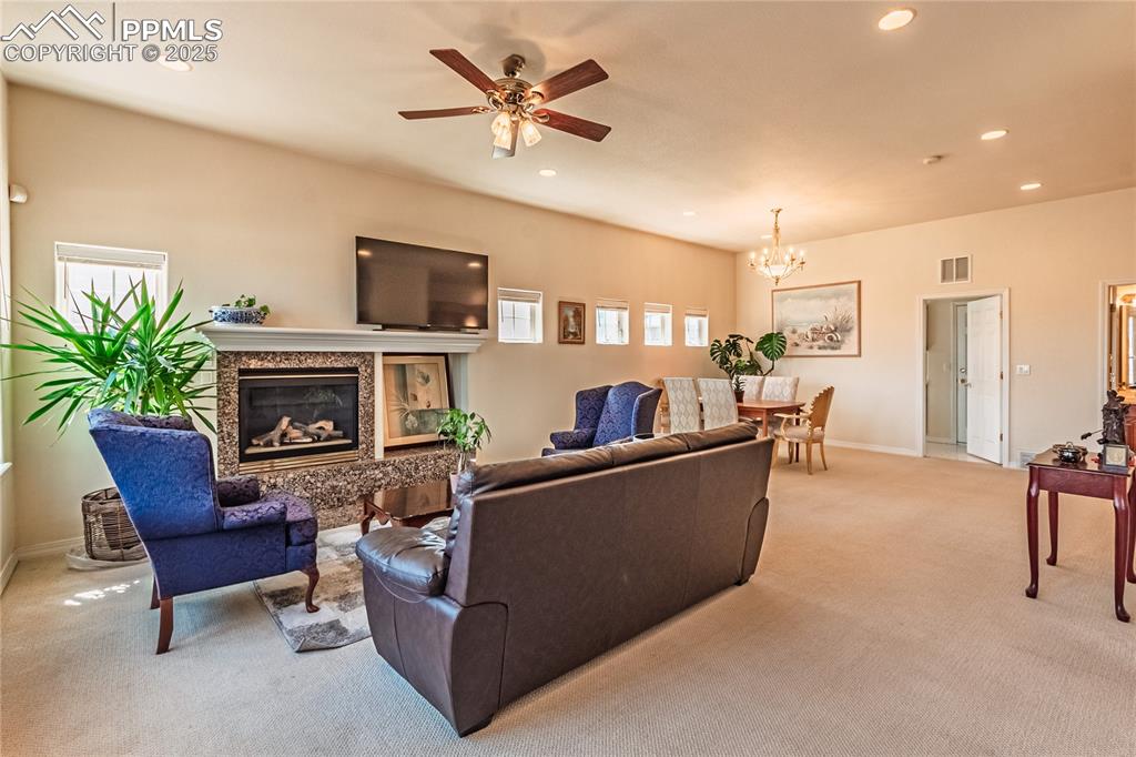 Image 8 of 49: Living room with visible vents, recessed lighting, and light colored carpet