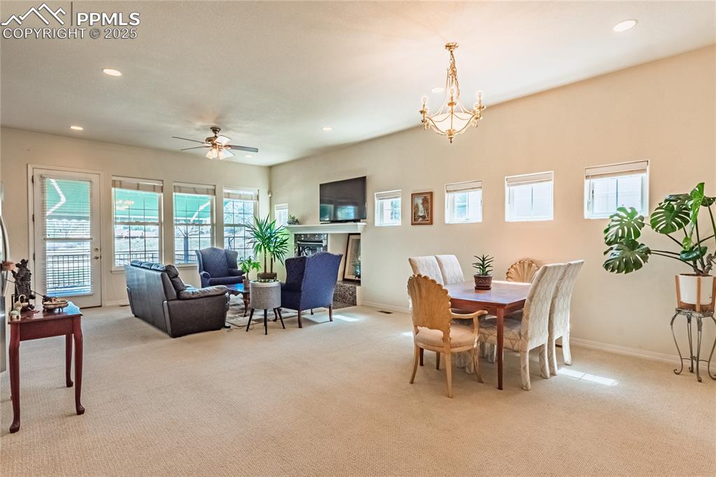 Image 9 of 49: Dining area featuring light colored carpet and recessed lighting