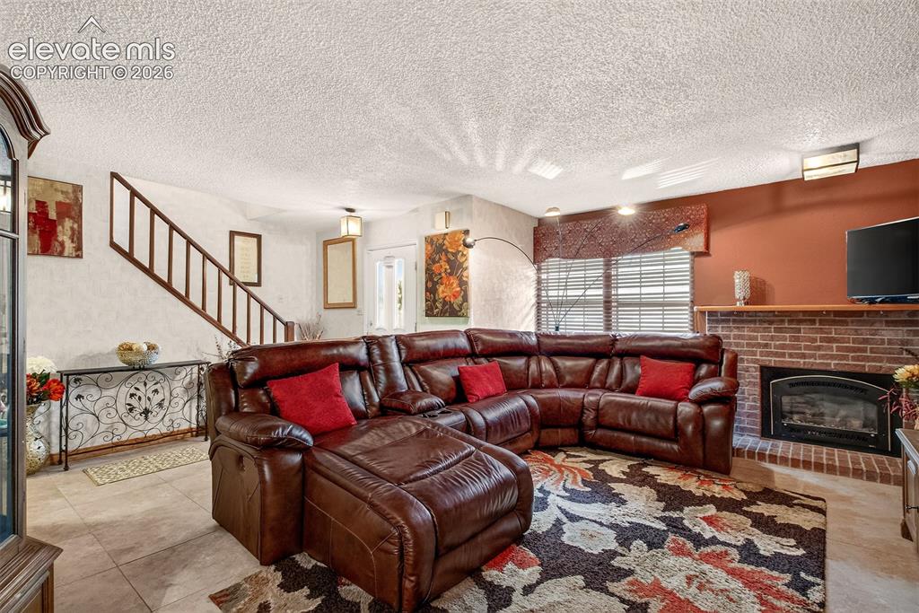 Image 2 of 27: Spacious Living Room with Fireplace