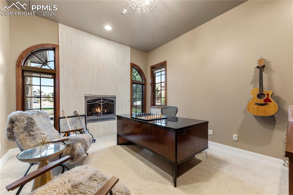 Image 6 of 46: Office with gas fire place and built-in cabinets