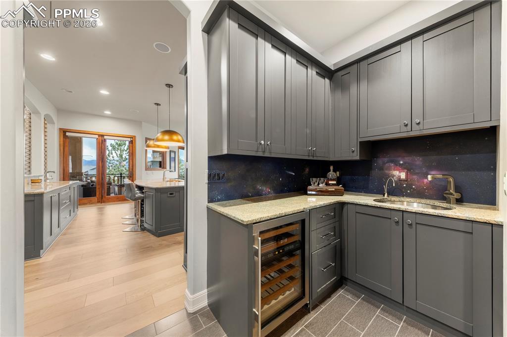 Image 8 of 46: Butlers pantry with sink and wine fridge
