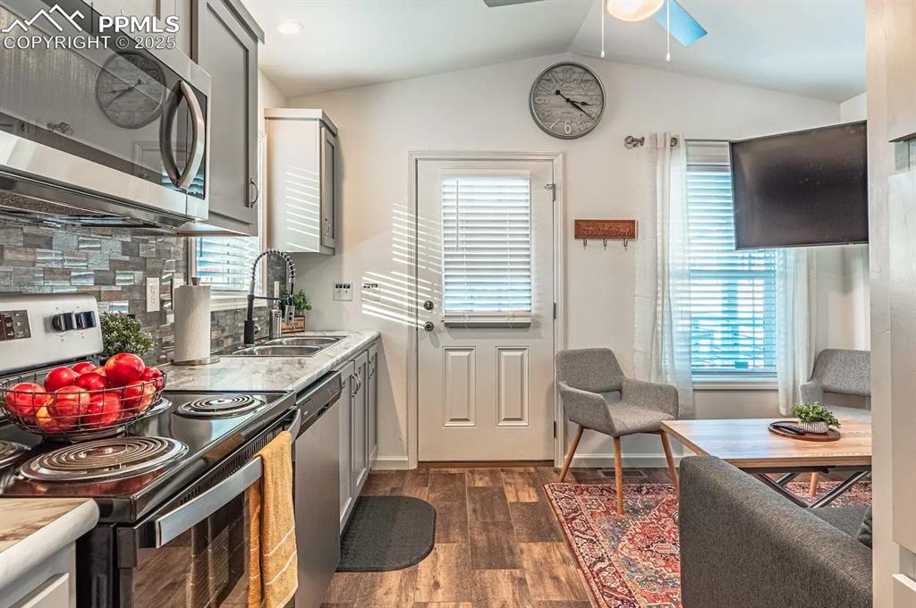 Image 12 of 27: Kitchen featuring stainless steel appliances, light countertops, gray cabin