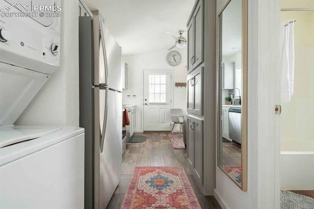 Image 15 of 27: Laundry area featuring ceiling fan, laundry area, a sink, wood finished flo