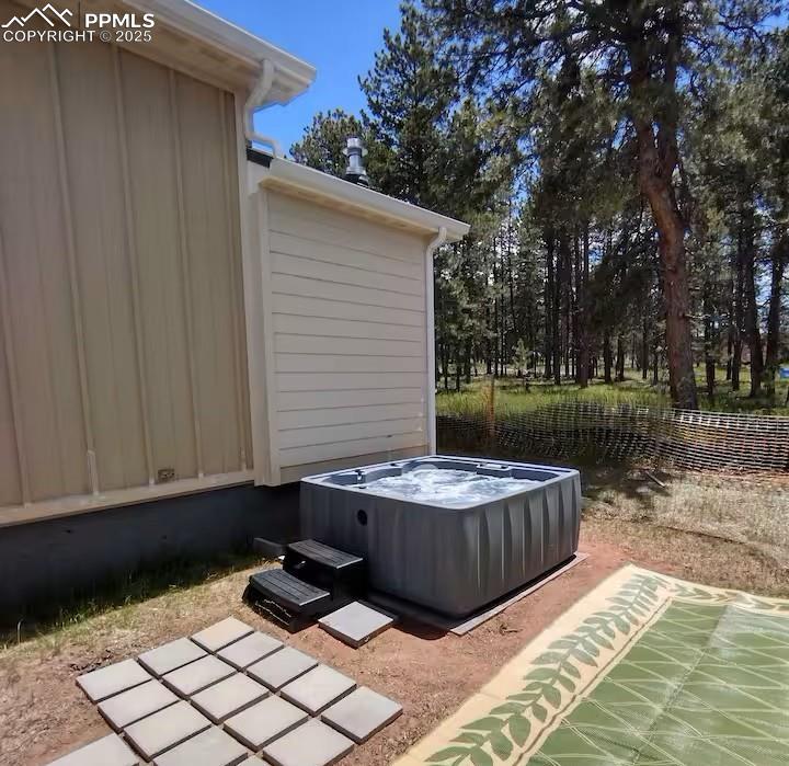 Image 27 of 27: View of patio featuring a hot tub and fence