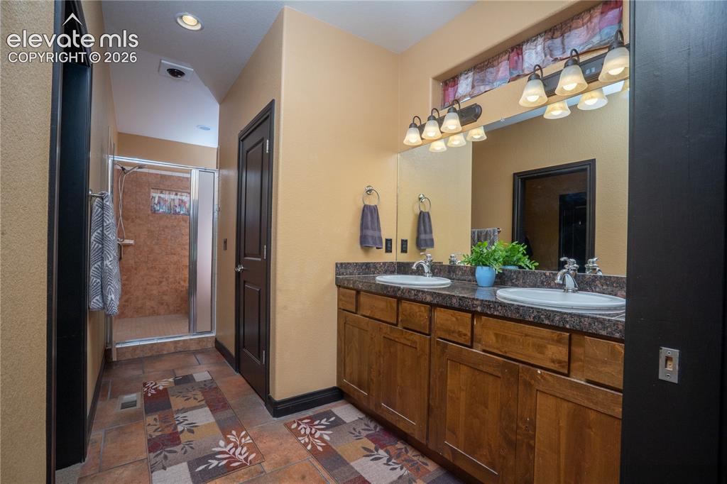 Image 19 of 47: A Dbl sink, large walk-in closet, and oversized shower