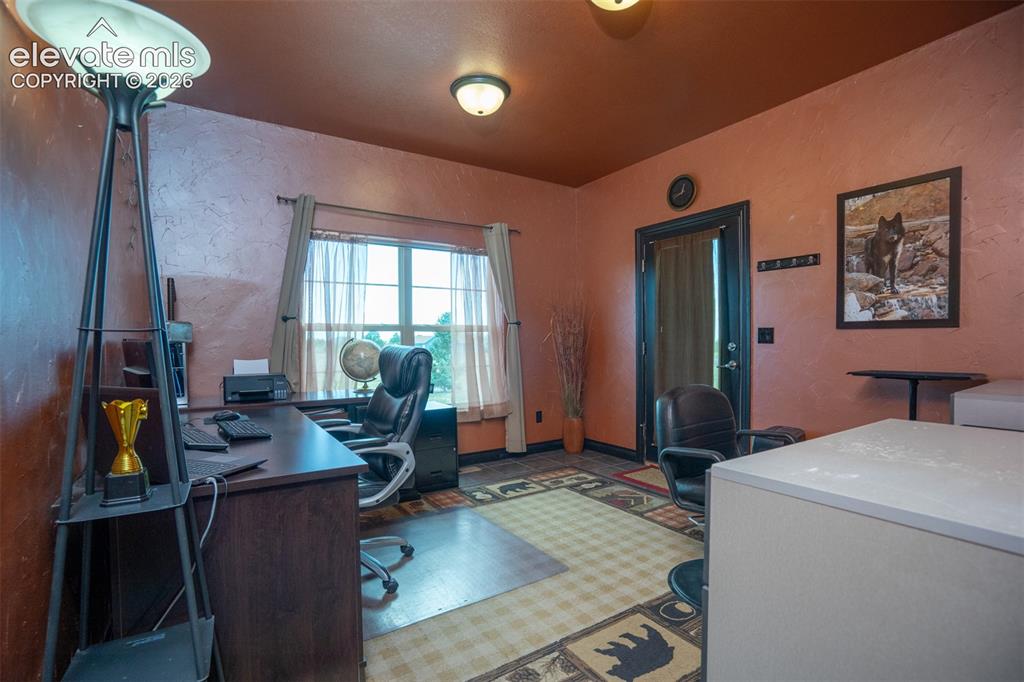 Image 22 of 47: An office with an outside entrance helps keep work away from the primary ho