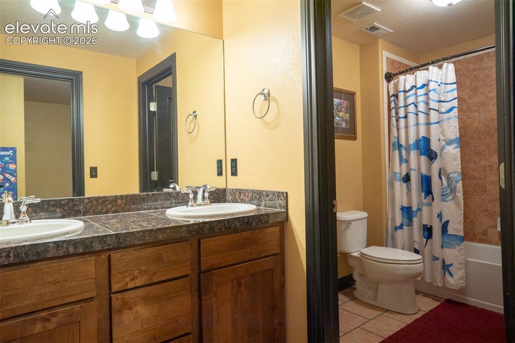 Image 33 of 47: Bathroom off the 4th bedroom has double vanity and sep door for the bath ar