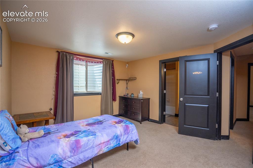 Image 34 of 47: 5th bedroom located on the basement level with it