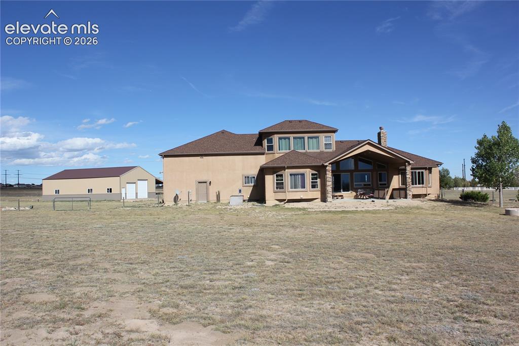 Image 41 of 47: A fire pit sits inside the almost 1/4 acre dedicated play and pet area