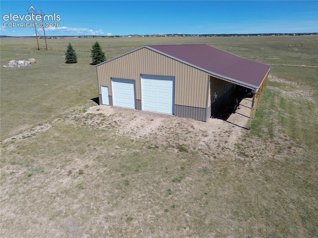 Image 42 of 47: This 40x60 pole barn currently stores the Big Boy toys. With a pull-thru RV