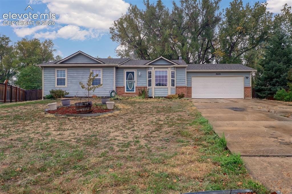 Caption: Single-story residence featuring horizontal siding, a brick facade, an attached two-car garage, a ba