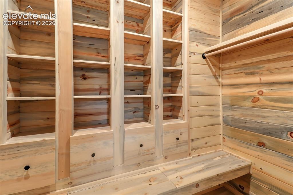 Image 10 of 34: Custom-built storage system featuring natural wood-finish shelving, integra