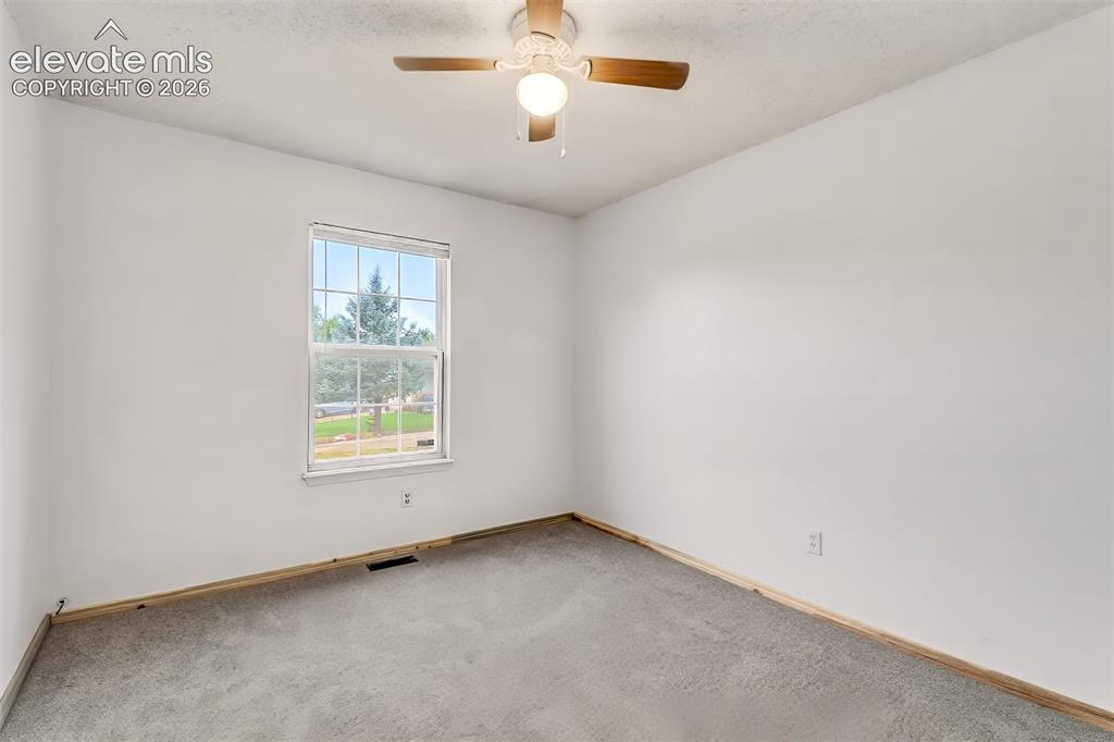 Image 14 of 34: Neutral-toned wall paint, neutral carpeting, single-hung window, and a ceil