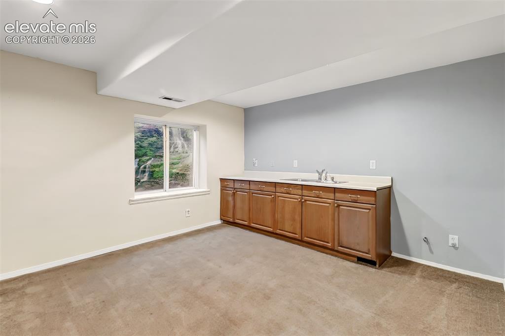Image 17 of 34: Built-in cabinetry with wood-finish doors, light-toned countertops, integra