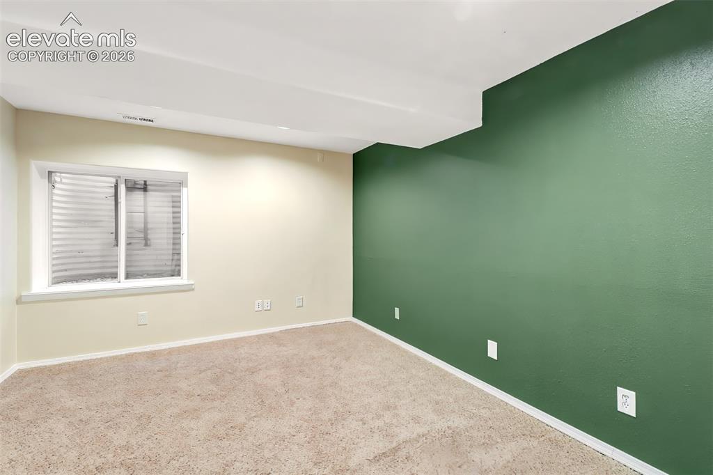 Image 20 of 34: Room interior featuring wall-to-wall carpeting, an inset window with a wind