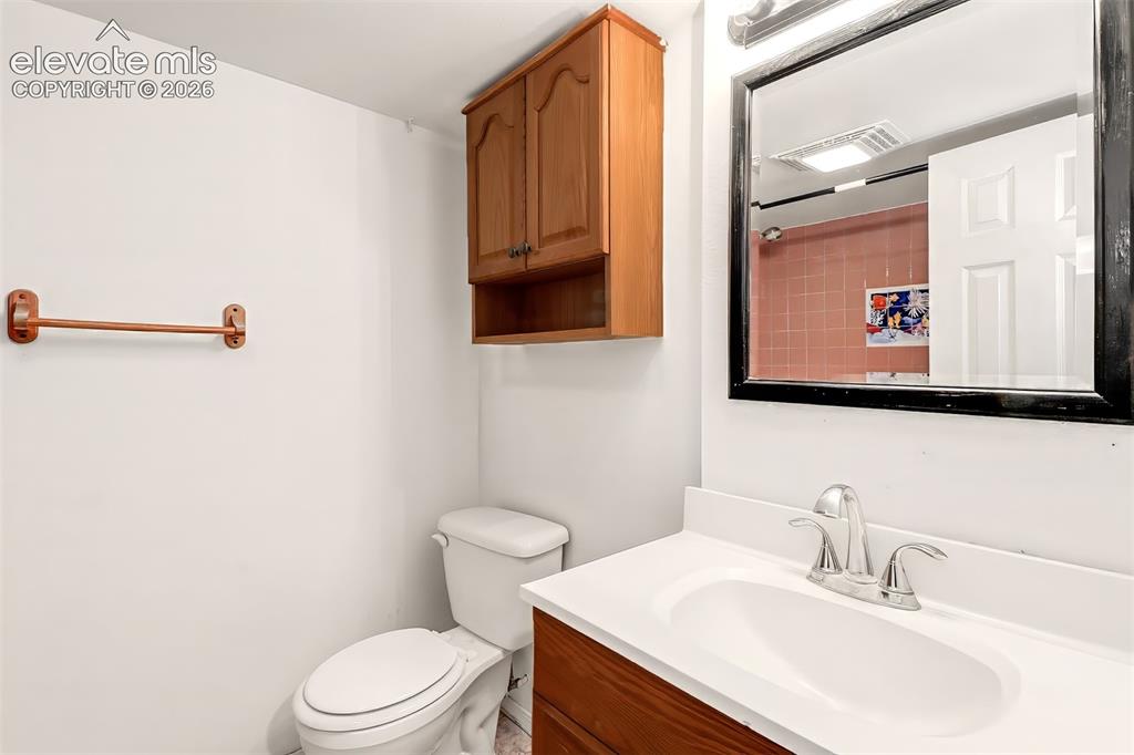 Image 23 of 34: Wood-finish cabinetry, wall-mounted storage cabinet, chrome dual-handle fau