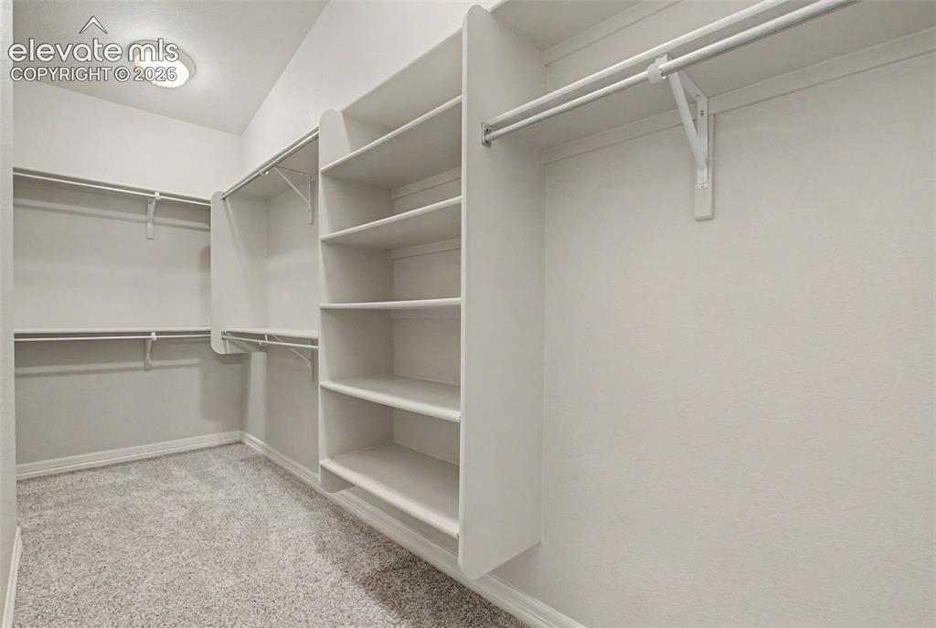 Image 22 of 46: Primary walk-in closet