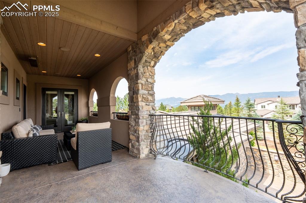 Image 27 of 50: Terrace with French Doors and a Mountain View