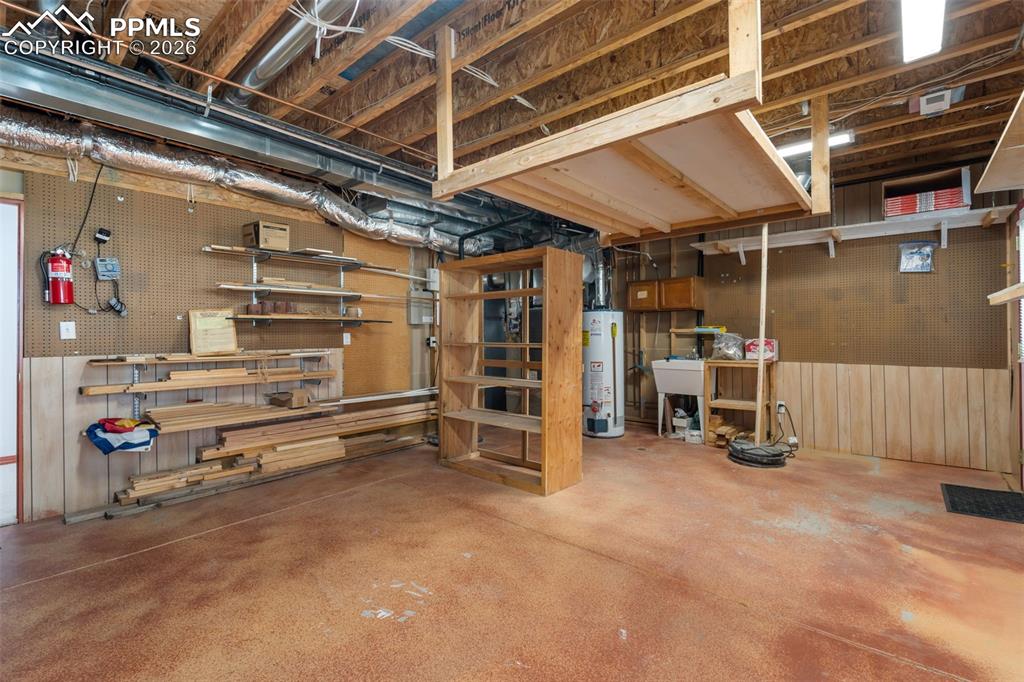 Image 26 of 33: Large work/storage area, another exterior door to lower deck