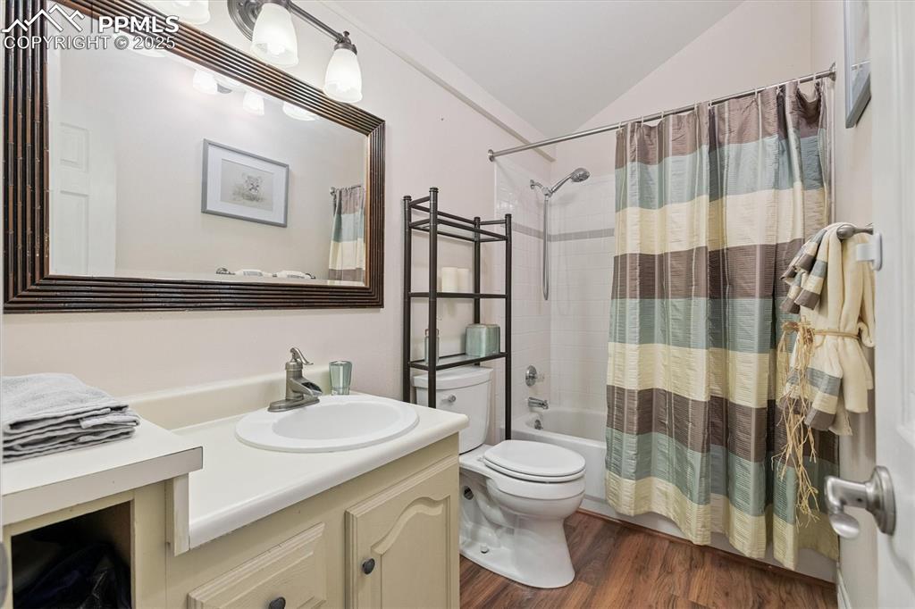 Image 10 of 22: Full bath with shower / bathtub combination with curtain, vanity, dark wood