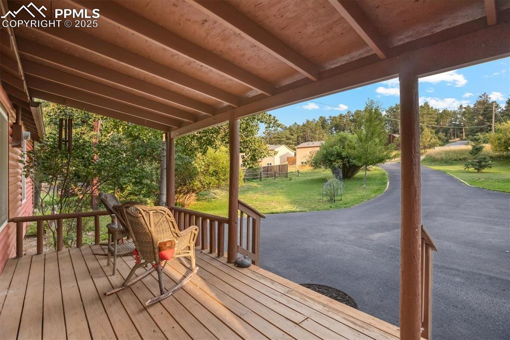 Image 2 of 22: Wooden deck with a lawn