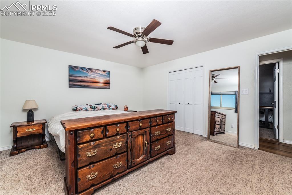 Image 12 of 48: Bedroom featuring ceiling fan, a closet, and light colored carpet