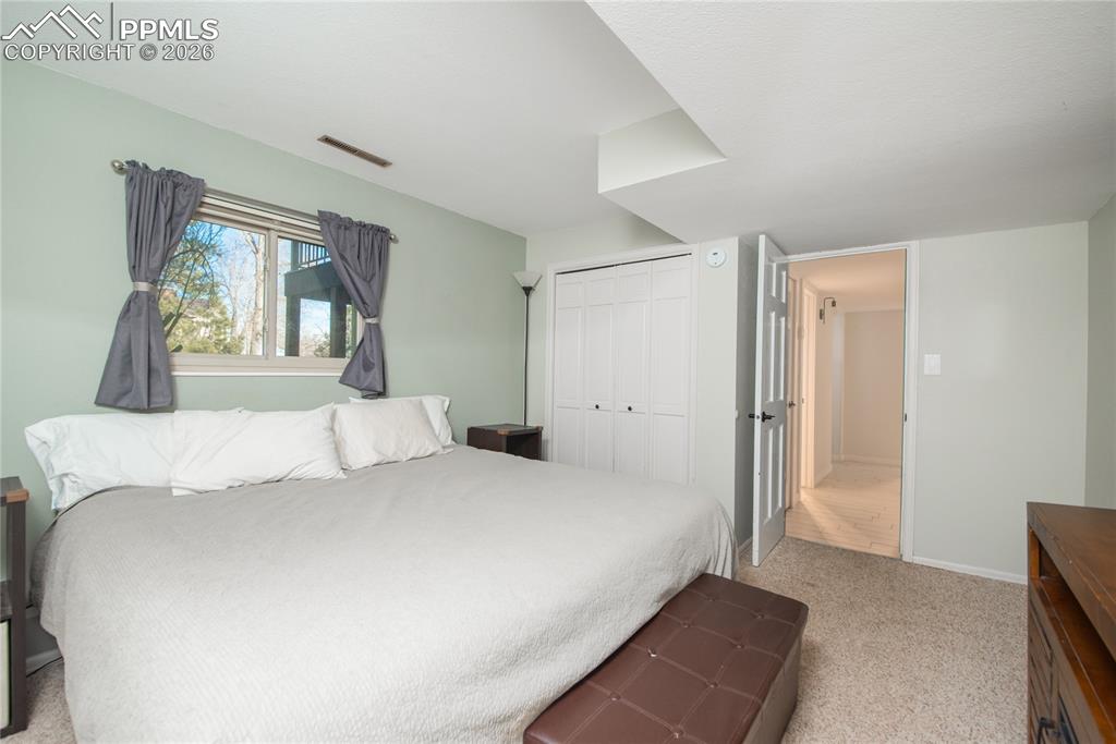 Image 26 of 48: Bedroom with light colored carpet and a closet