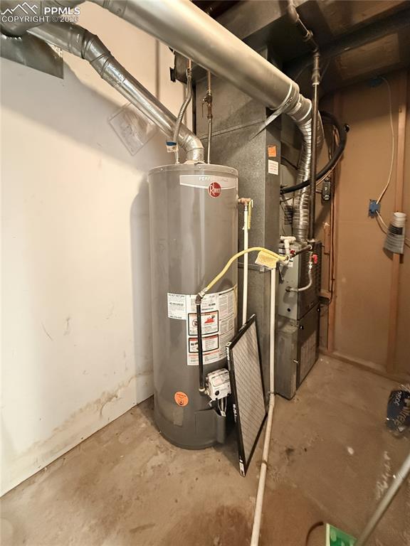 Image 32 of 48: Utility room with water heater and heating unit