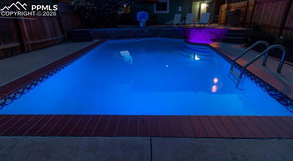 Image 36 of 48: View of pool featuring a fenced backyard and patio surround