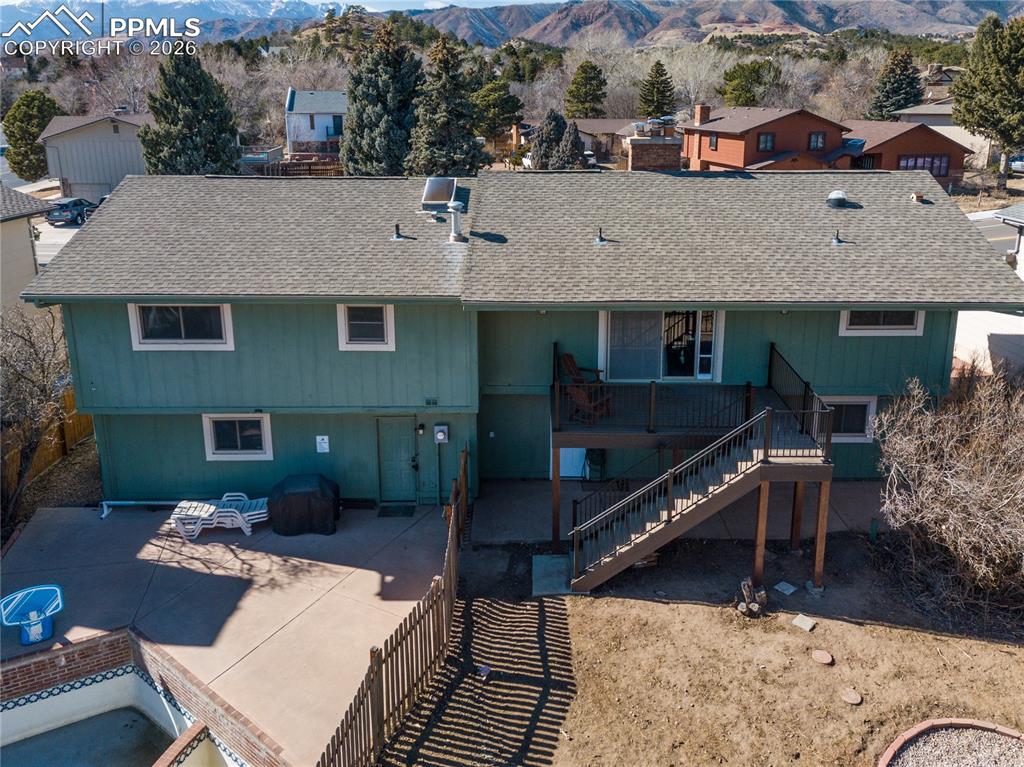 Image 37 of 48: Rear view of property with roof with shingles, a mountain view, and a patio
