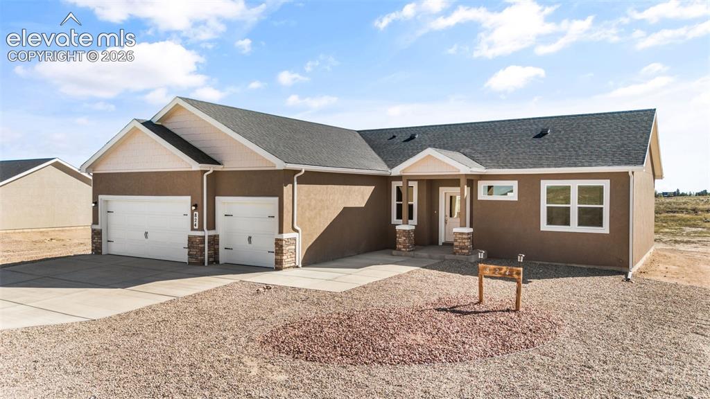 Image 2 of 40: Ranch-style residence featuring a stucco exterior, two-car garage, and an i