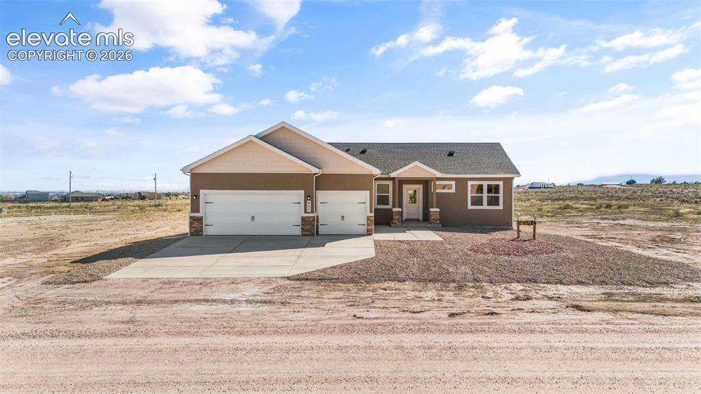 Image 33 of 40: Contemporary single-story residence with a two-car garage, concrete drivewa