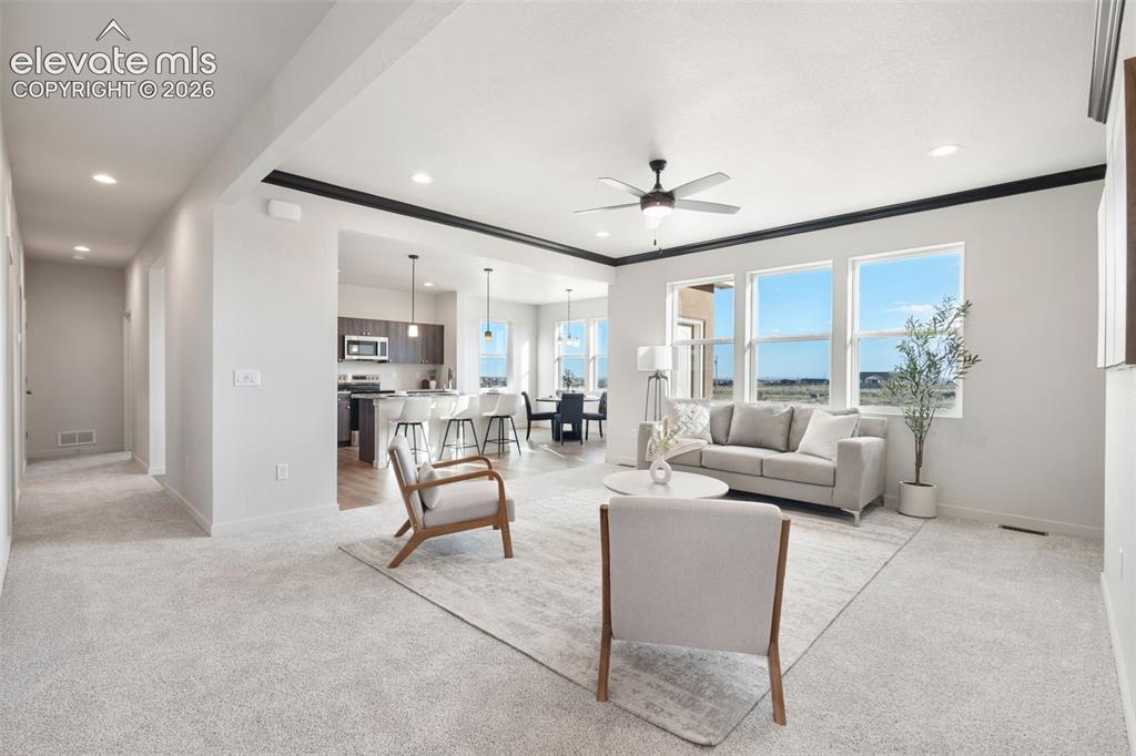 Image 5 of 40: Open-concept living space with recessed lighting, a ceiling fan, and large 