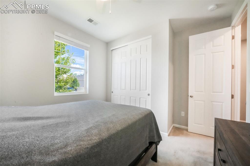 Image 11 of 47: 2nd bedroom with carpet and large closet